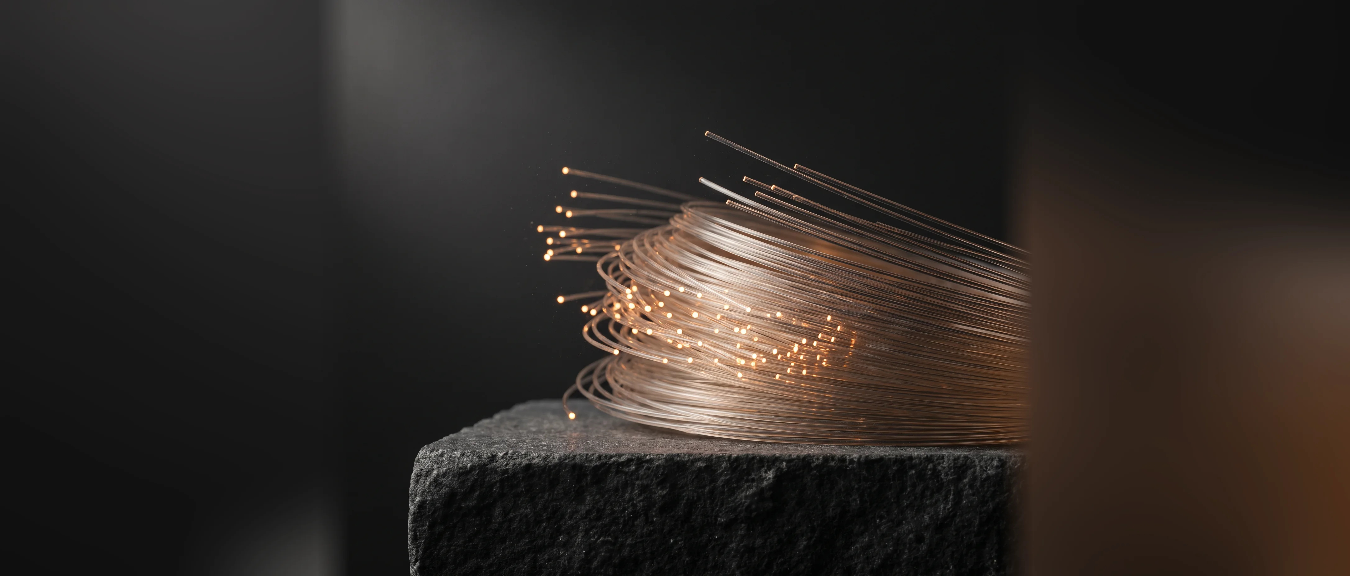 A coil of optical fibre, the cut ends lit