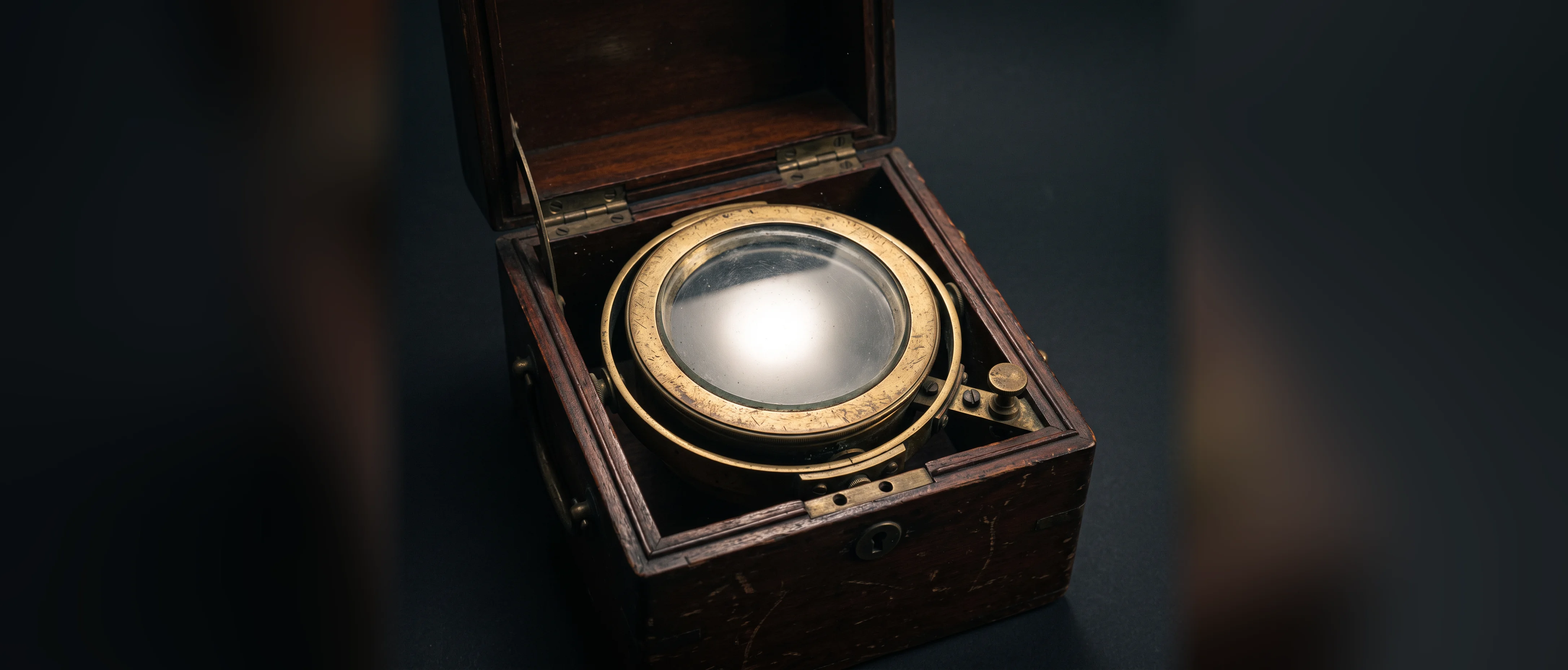 An antique marine chronometer in its case